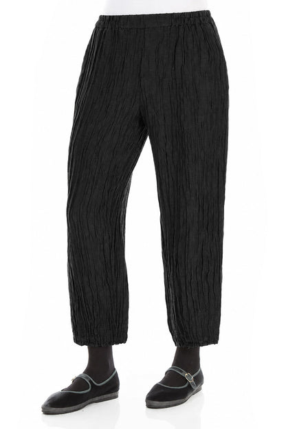 Pantalon fuselé en soie et lin noir froissé