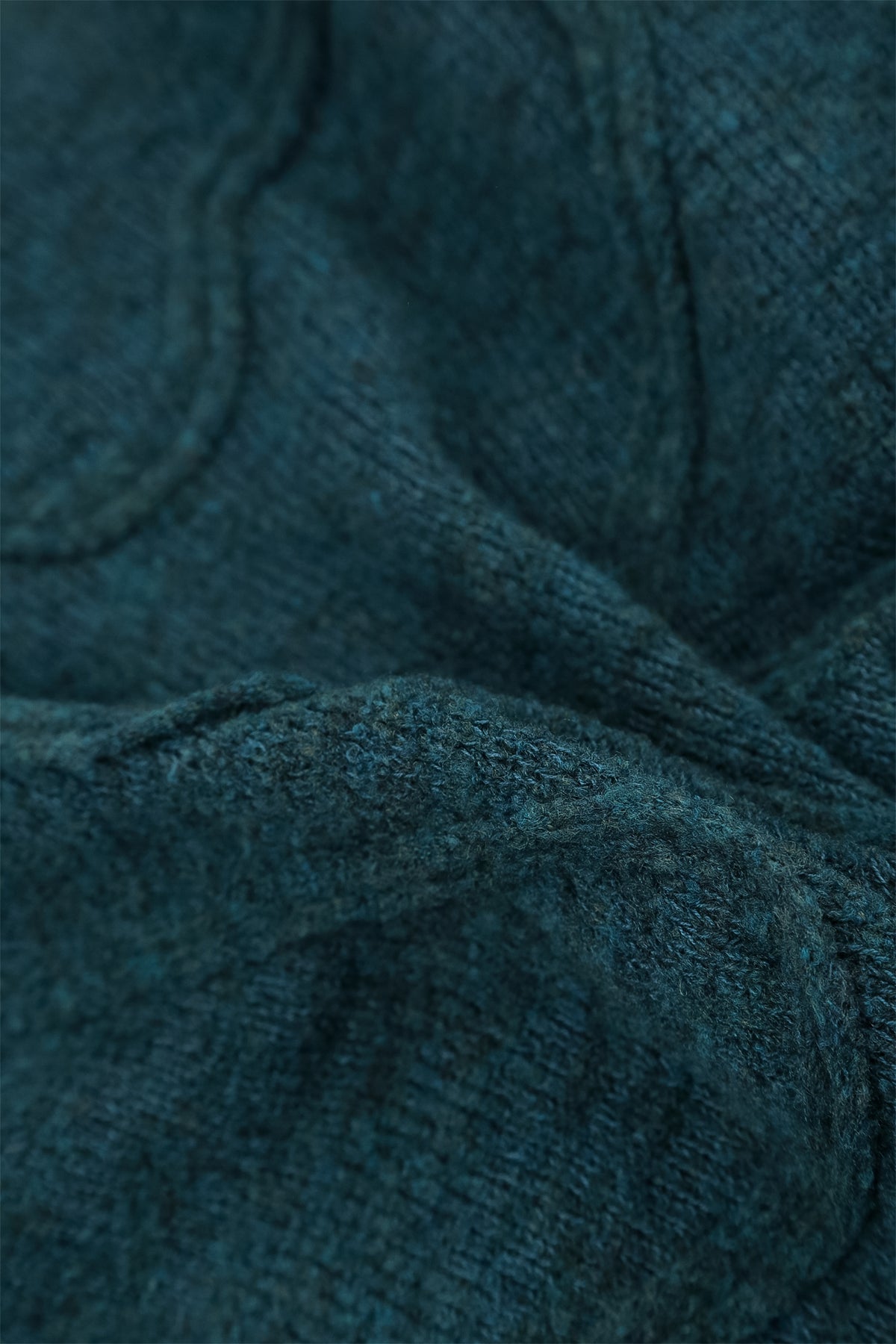Pull en laine bleu sarcelle à couture ondulée