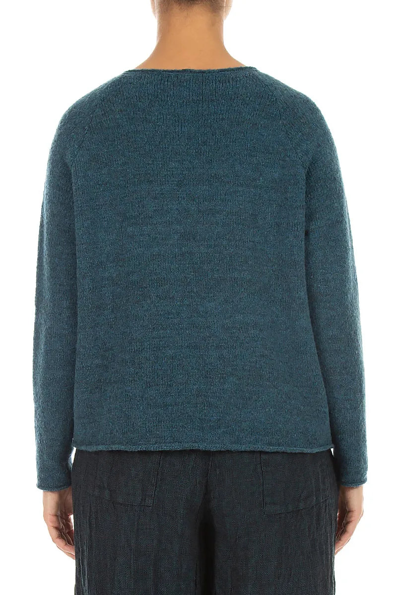 Pull en laine bleu sarcelle à couture ondulée