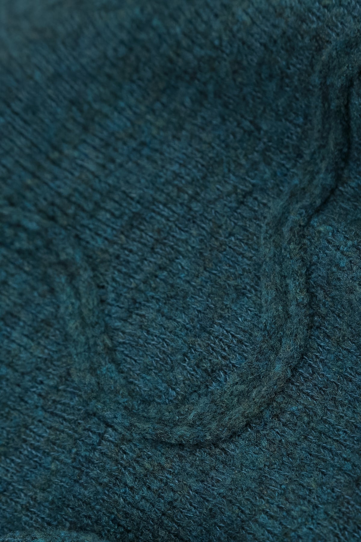 Pull en laine bleu sarcelle à couture ondulée