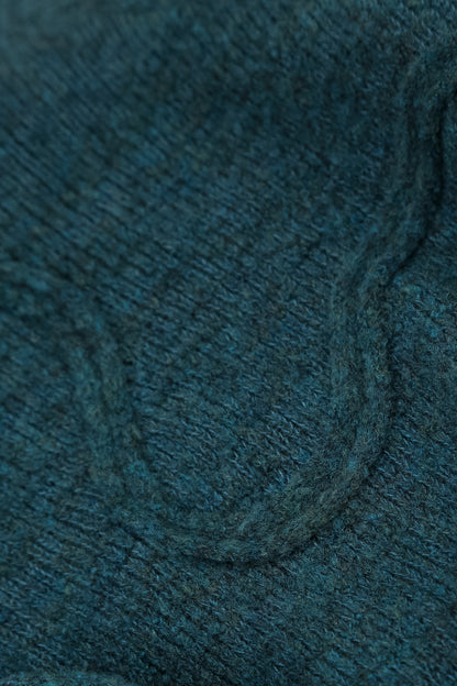 Pull en laine bleu sarcelle à couture ondulée